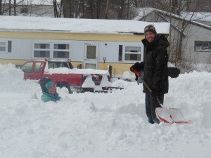 Jeff shoveling - Jillian sitting in the snow (neighbors).