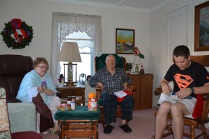 Mom, Dad, Joe opening their stockings